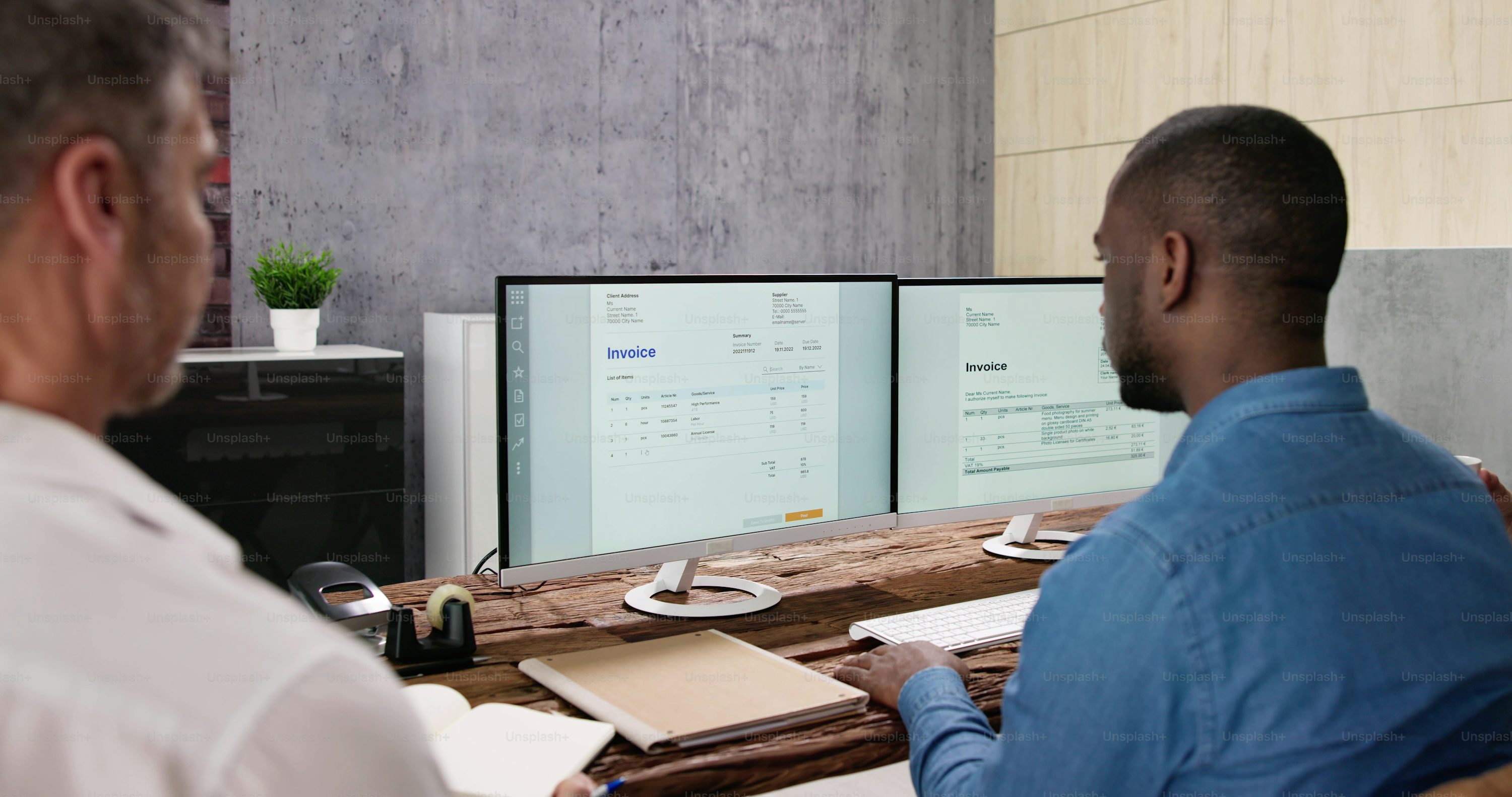 Team reviewing invoice records on accounting software screens.